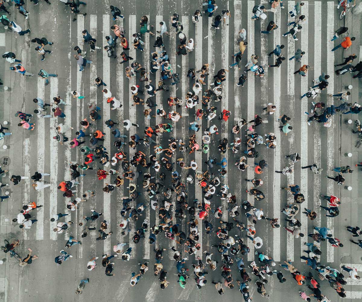 Aerial view of large crowd crossing road in Latin America