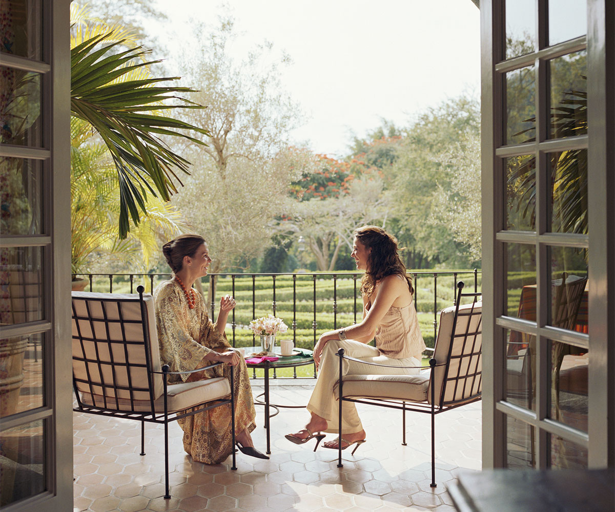 Two women speaking on patio
